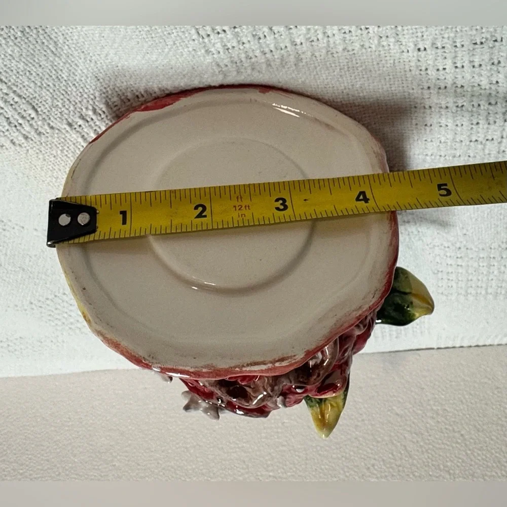 This is a vintage ceramic strawberry candle or tealight holder,